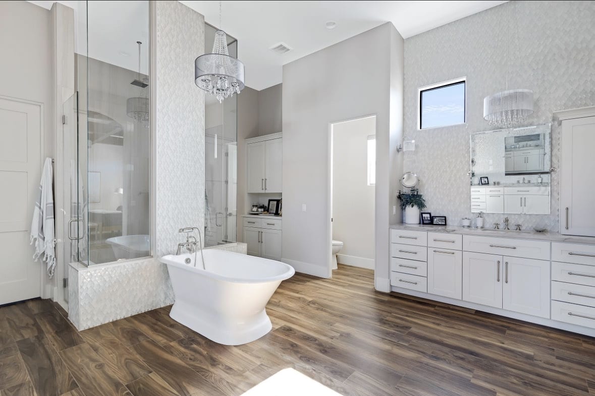 Primary bath with freestanding tub and chandelier
