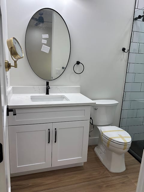 Guest bathroom with oval mirror